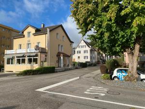 a street with houses and a car parked on the road at Bellavista Home in Trimbach