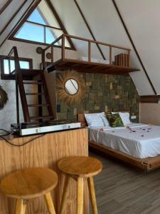 a bedroom with a bed and two stools at Solo-A-Villa in Paje +13 photos