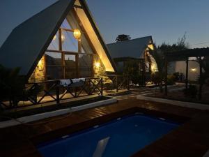 a house with a swimming pool in front of it at Solo-A-Villa in Paje