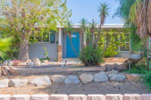 a house with a blue door and some trees at @ Marbella Lane - 4BR Near Morongo Casino & Outlet Ldry+P in Banning