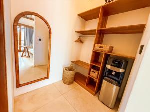 a kitchen with a mirror and a refrigerator at Muzeum Villas II Bingin in Bingin Beach