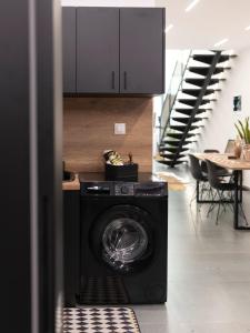 a washer and dryer in a room with a staircase at myloft luxury stay in Edessa