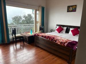 a bedroom with a bed and a table and a window at Sanchi's Homestay 2BHK in Bhowāli