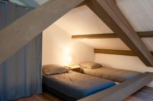 two beds in a room with an attic at Cannes luxury apartment in Cannes