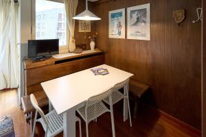 a kitchen with a white table and two chairs at Casa Elena in Breuil-Cervinia +4 photos