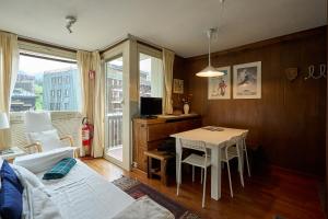 a living room with a table and a couch at Casa Elena in Breuil-Cervinia