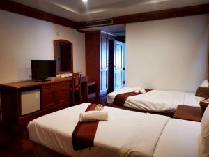 a hotel room with two beds and a television at Lifeup care and hotel in Ban Mai +25 photos