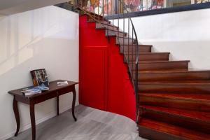a red stairwell with a wooden table and a red wall at Zámek Ostrolov in Ostrolovský Újezd