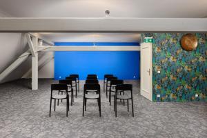 a group of chairs in a room with a blue wall at Zámek Ostrolov in Ostrolovský Újezd +33 photos