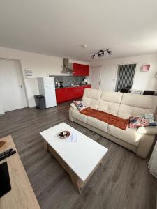 グラヴリーヌにあるAppartement à proximité de la plageのソファとコーヒーテーブルのあるリビングルーム