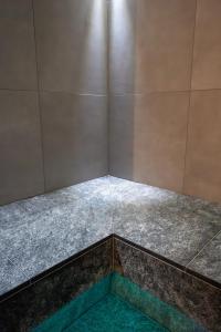 a corner of a room with a tile floor at Swiss Historic & Garten Hotel Villa Carona in Carona