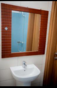 a bathroom with a sink and a mirror and a shower at AVELORA HOMES Paje in Fumba +15 photos