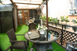 a patio with a table and chairs on a balcony at Hotel Old Rustaveli in Tbilisi City