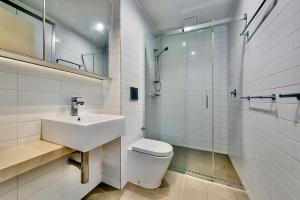 a bathroom with a sink and a toilet and a shower at The Padbury Suites 1-Premium City Apartment in Karratha +32 photos