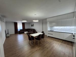 a kitchen and living room with a table and chairs at Eden House in Kukës