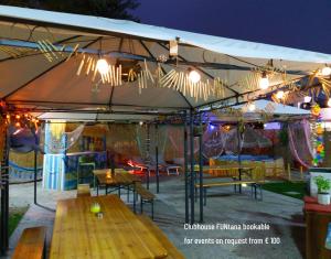 a tent with tables and chairs under it with lights at Mobile Fontana Oasis in Castelnuovo del Garda +81 photos
