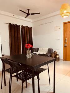 a dining room with a black table and chairs at Springs Forever in Gachibowli +30 photos