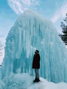 a man standing in front of an ice sculpture at Lakes and peaks in Srinagar