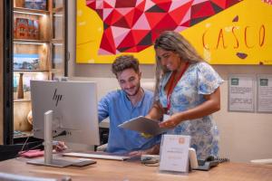 a man and a woman looking at a tablet at Joya del Casco Boutique Hotel by Shiadu in Seville