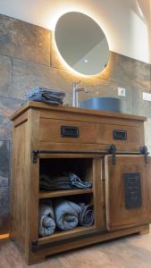 a bathroom vanity with a sink and a mirror at La Maison 91 in Croix-en-Ternoise +80 photos