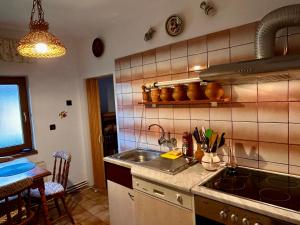 a kitchen with a sink and a counter top at Kata Home by RentALL in Gheorgheni