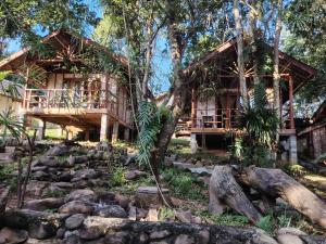 a house in the woods with a rocky yard at Nirvana Archipel Resort in Vang Vieng