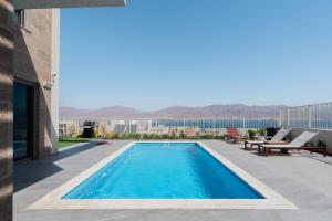 a swimming pool on the roof of a building at Villa Dekel - By Harim in Eilat