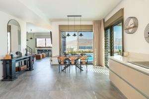 a kitchen and dining room with a table and chairs at Villa Dekel - By Harim in Eilat