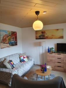 a living room with a couch and a table at Wünschel Stube in Gossersweiler-Stein