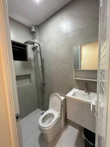 a small bathroom with a toilet and a sink at Casa Leveria Unit 6 with Balcony, Inquire Parking Availability in Imus