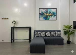 a living room with a couch and a table at Aga's Transient House in Baguio
