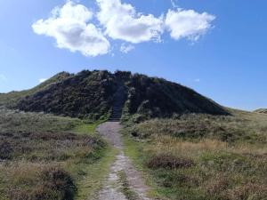 a heart shaped cloud above a dirt road on a hill at 6 person holiday home in Rømø-By Traum in Rømø Kirkeby