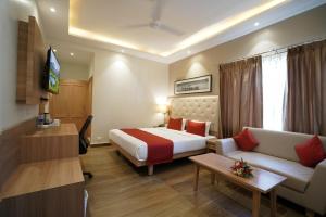 a hotel room with a bed and a couch at Kalinga Hotel in Jodhpur
