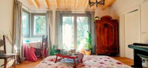 a bedroom with a bed and a large window at I Custodi del Bosco in Gorizia