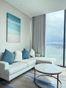 a living room with a couch and a table at Happy home happy sunrise and sunset in Ha Long