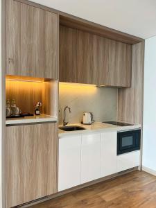 a kitchen with white cabinets and a sink at Happy home happy sunrise and sunset in Ha Long