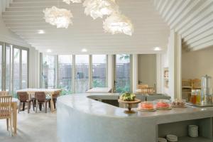 a kitchen and dining room with a table and chairs at The Odyssey Chiang Mai in Chiang Mai
