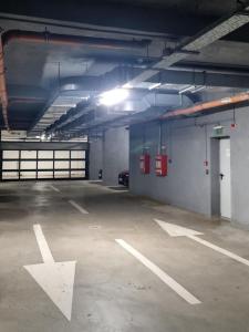 an empty parking garage with a car parked in it at Studio Nova - Minimalist and Elegant with Parking in Bucharest