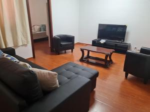 a living room with a couch and chairs and a table at Geovanny house in Funchal