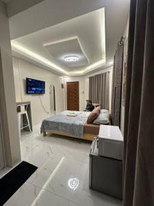 a bedroom with a bed and a tv on the ceiling at Casa Leveria Unit 9 with Balcony, Inquire Parking Availability in Imus +3 photos