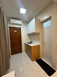 a small kitchen with a sink and a door at Casa Leveria Unit 9 with Balcony, Inquire Parking Availability in Imus
