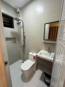 a small bathroom with a toilet and a sink at Casa Leveria Unit 9 with Balcony, Inquire Parking Availability in Imus