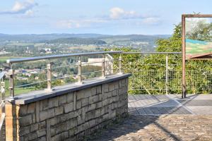 a balcony with a railing on a brick wall at l'Asperule in Rouvroy