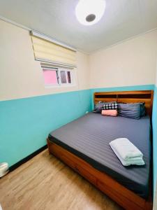une chambre avec un grand lit dans une pièce dans l'établissement Zenmist Properties- Studio Type Condo, à Baguio