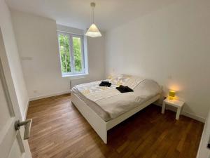 a bedroom with a bed and a window and two lamps at Le ONZE in Longwy