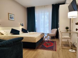 ラヴェンナにあるArtemis Roomsのベッドとソファのあるホテルの部屋