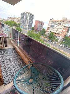 a bench on a balcony with a view of a city at Laura's Residence Luxury in Craiova