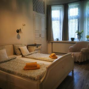 a bedroom with a bed with two towels on it at Kúria apartman private wellness with garden and pool in Budapest +155 photos