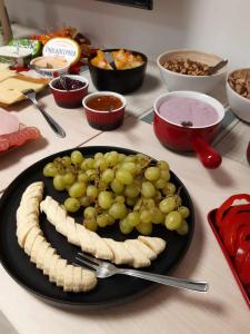 a plate of food with grapes and cheese on a table at HunGasthaus 08 in Mariazell +6 photos