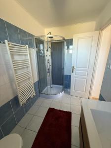 a bathroom with a shower and a glass door at Charming Mountain Escape in Sospel, Perfect for Nature Lovers in Sospel